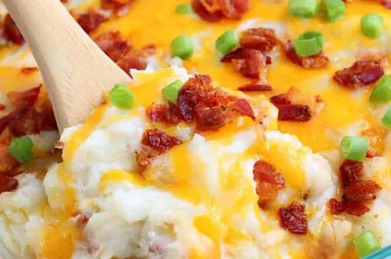 Loaded Baked Potato Casserole topped with cheese, bacon, and green onions