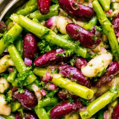 Colorful Three Bean Salad with beans, peppers, and dressing in a bowl
