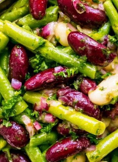 Colorful Three Bean Salad with beans, peppers, and dressing in a bowl