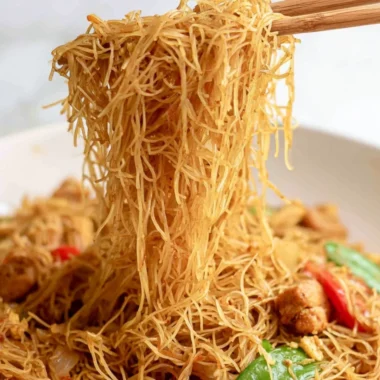 Cozy Singapore curry noodles served in a bowl with fresh herbs and spices