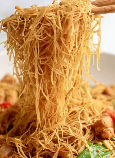 Cozy Singapore curry noodles served in a bowl with fresh herbs and spices