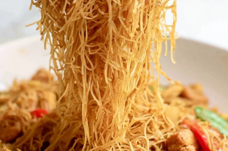 Cozy Singapore curry noodles served in a bowl with fresh herbs and spices