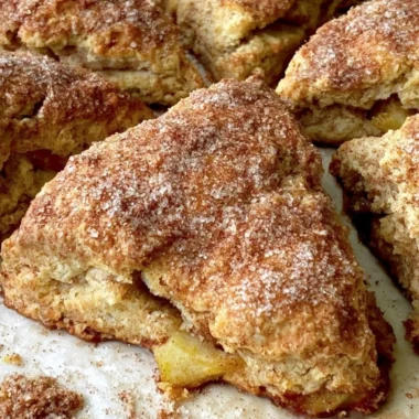 Freshly baked cozy apple scones on a wooden table