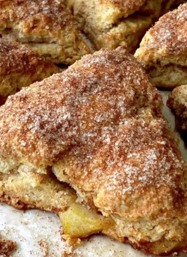 Freshly baked cozy apple scones on a wooden table