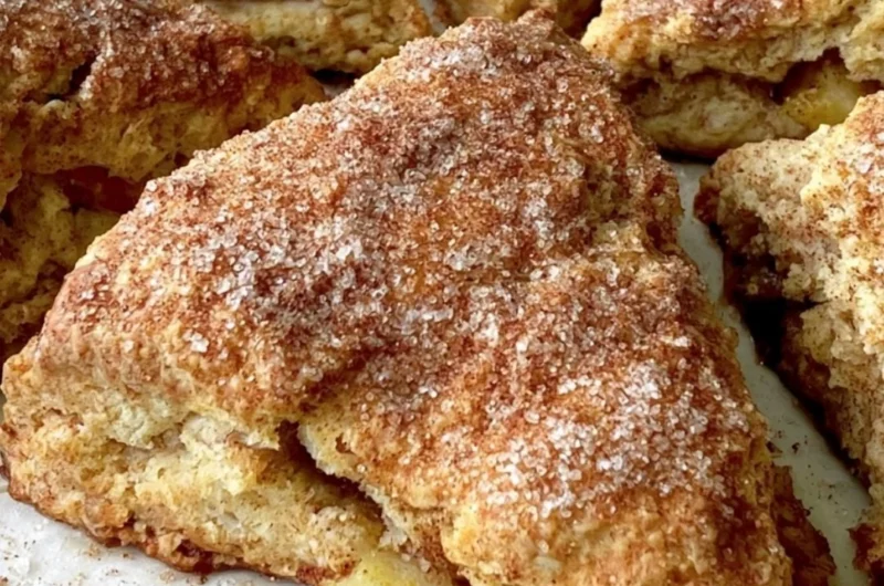 Freshly baked cozy apple scones on a wooden table