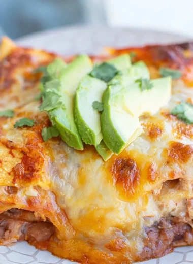 Cozy Bean and Cheese Enchilada Casserole served warm in a baking dish