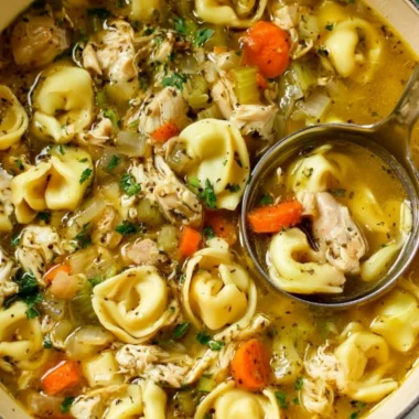 Bowl of cozy Chicken Tortellini Soup with fresh ingredients
