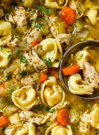 Bowl of cozy Chicken Tortellini Soup with fresh ingredients
