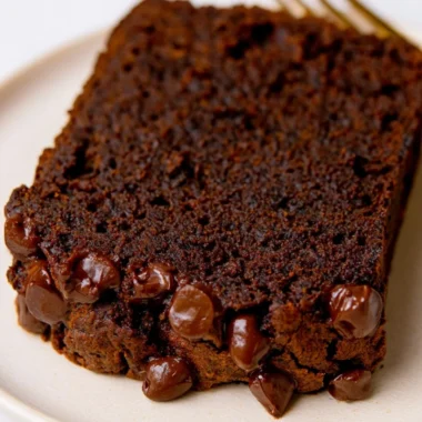 Sliced double chocolate pumpkin bread with chocolate chips on a plate