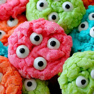 Plate of gooey monster cookies with chocolate chips and colorful M&Ms