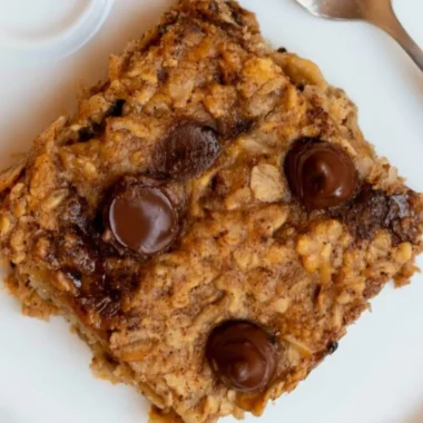 Homemade Banana Oatmeal Bars topped with sliced bananas and oats.