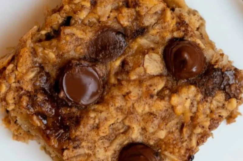 Homemade Banana Oatmeal Bars topped with sliced bananas and oats.