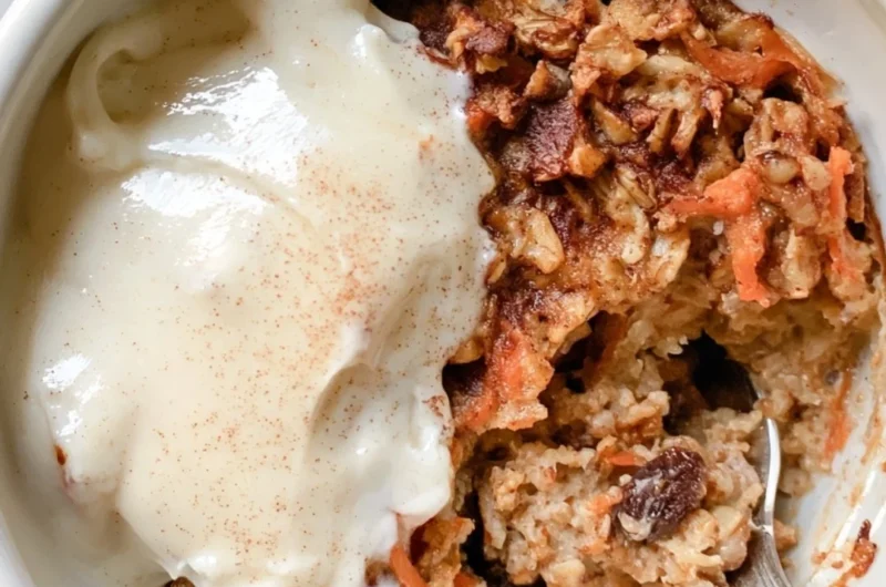 Carrot cake baked oatmeal topped with nuts and cream cheese drizzle