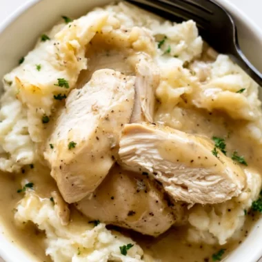 Delicious Instant Pot chicken and gravy served in a bowl with rice