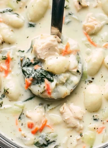 Bowl of Olive Garden chicken gnocchi soup with fresh herbs and ingredients