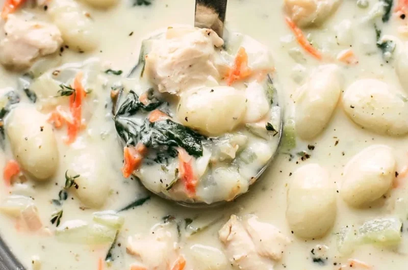 Bowl of Olive Garden chicken gnocchi soup with fresh herbs and ingredients