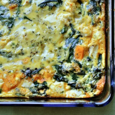 Spinach and Feta Egg Bake served in a dish with fresh herbs