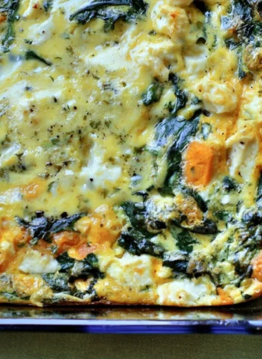 Spinach and Feta Egg Bake served in a dish with fresh herbs