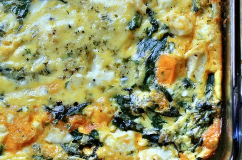 Spinach and Feta Egg Bake served in a dish with fresh herbs